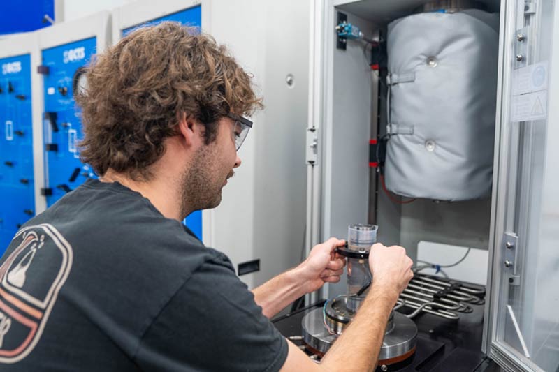 Student working on machine in rock mechanics lab