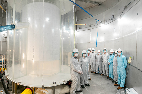 Members of the LZ team in the LZ water tank after the outer detector installation. Credit: Matthew Kapust/Sanford Underground Research Facility