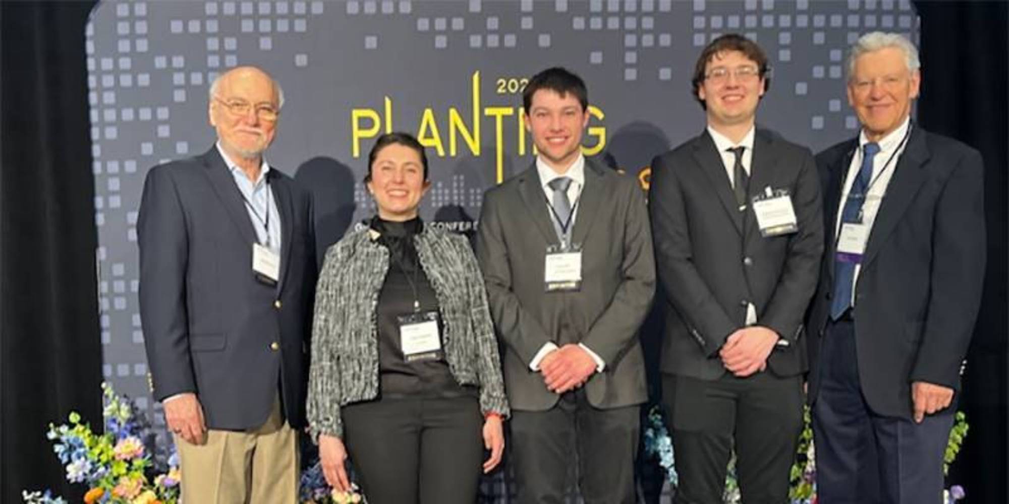  Mines students Carson Daly and Zach Holloway, middle and second from right, claimed second place and $10,000. Also pictured are business mentors Merle Symes, left, and Jim Quinn, right.