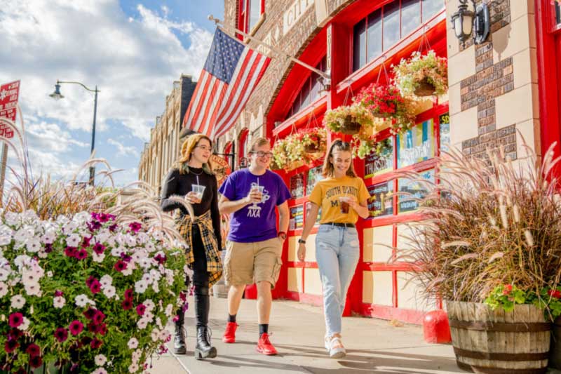 Group of students walking around downtown Rapid City. geoscientist